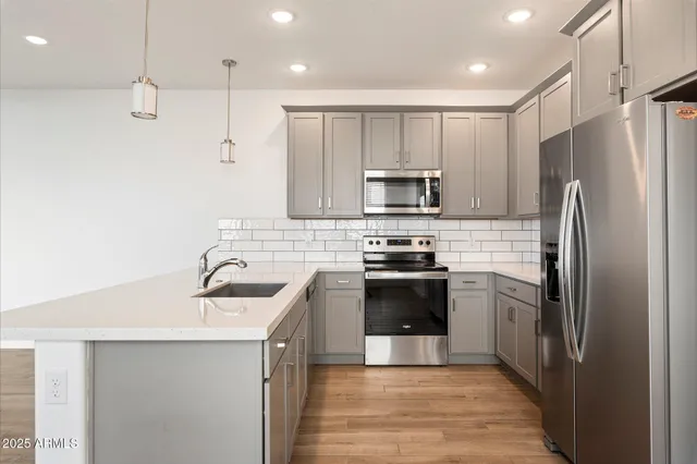 a kitchen with a sink stainless steel appliances and cabinets