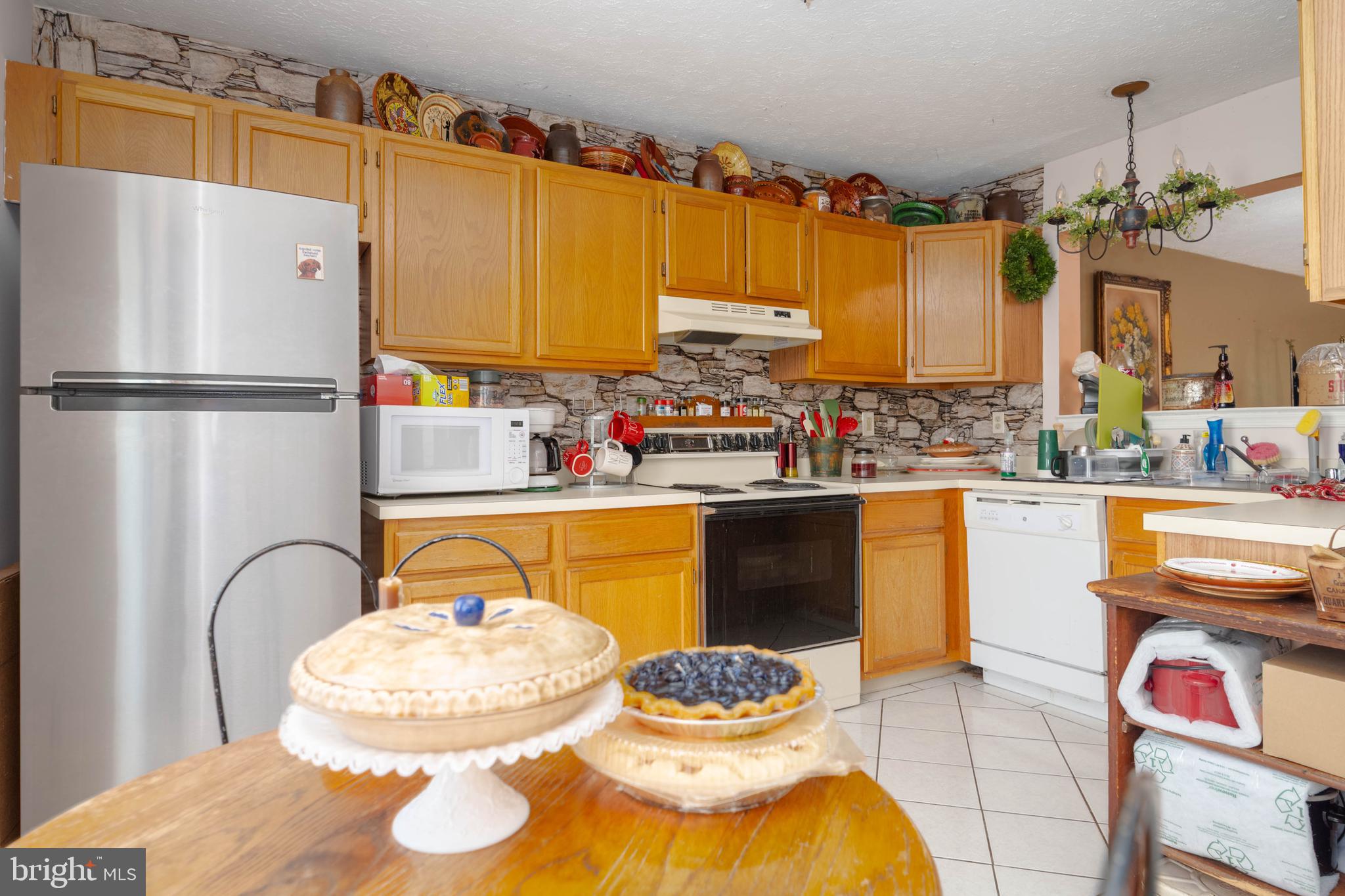 645 Nollmeyer Road Baltimore, MD 21220 - Photo 8 of 19 a kitchen with a refrigerator and a table