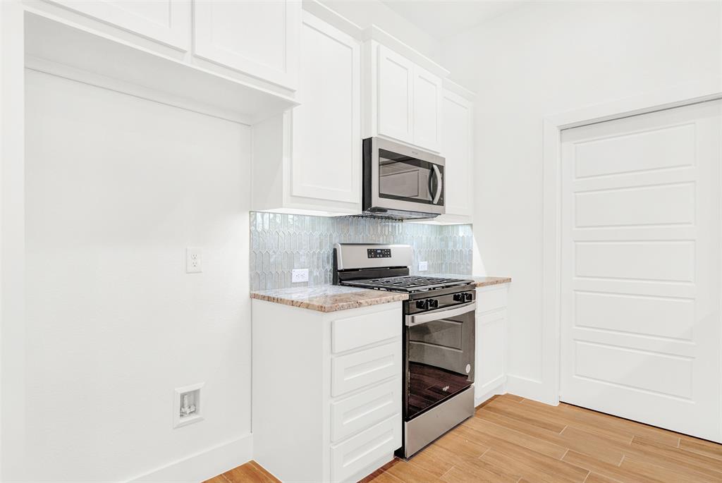 3676 Rickshaw Drive, Unit A Dallas, TX 75229 - Photo 5 of 21 SS refrigerator(not shown) next to SS range and microwave