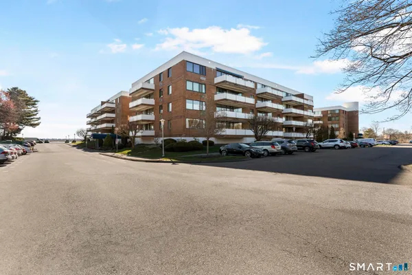 a view of a tall building next to a road