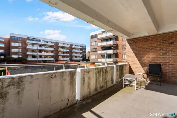 a view of a living room with a table and chairs