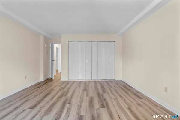 a view of a room with wooden floor