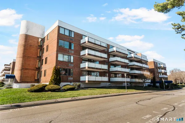 a view of a house with a large window and a yard