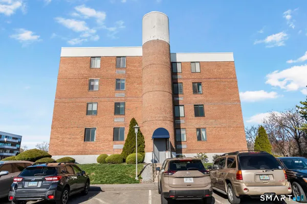 a view of a tall building next to a road