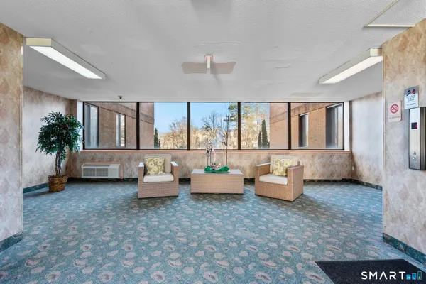 a living room with furniture and large windows