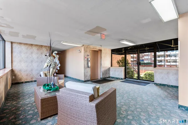 a living room with furniture and a floor to ceiling window