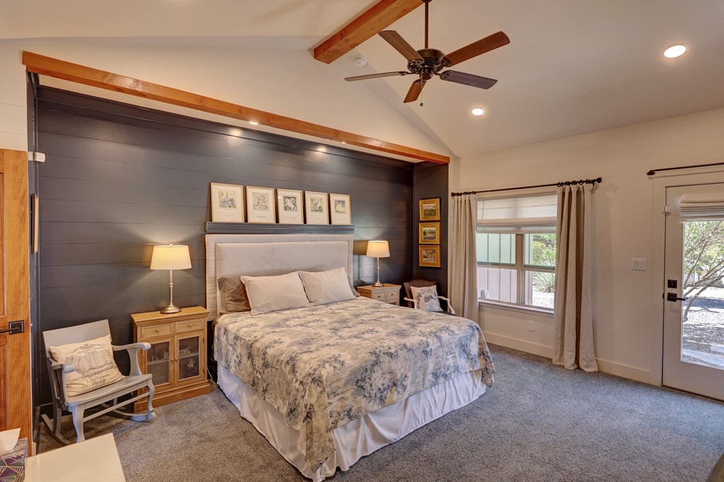 127 Keagan Drive Hunt, TX 78024 - Photo 11 of 12 a bedroom with a large bed chandelier and a window