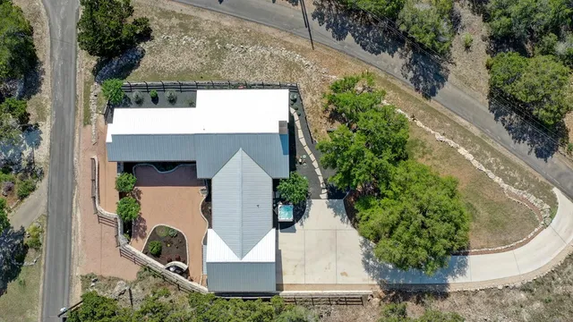 an aerial view of a house with a yard