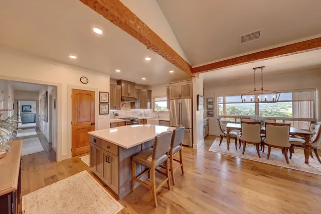 a large kitchen with a table and chairs