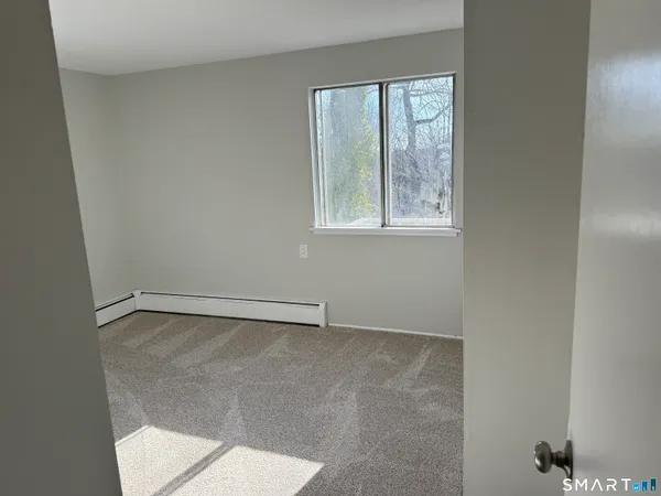 a view of an empty room with a window