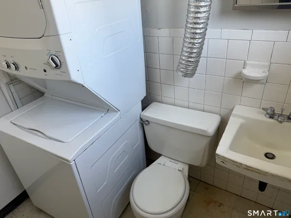 a white toilet sitting next to a bathroom sink