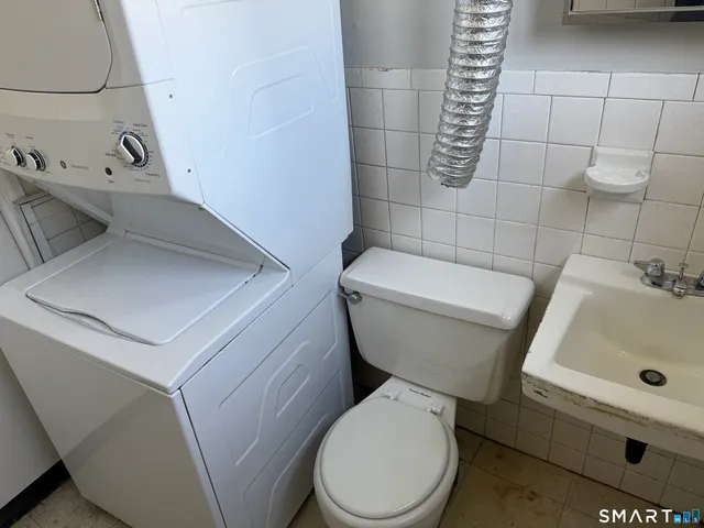 a white toilet sitting next to a bathroom sink