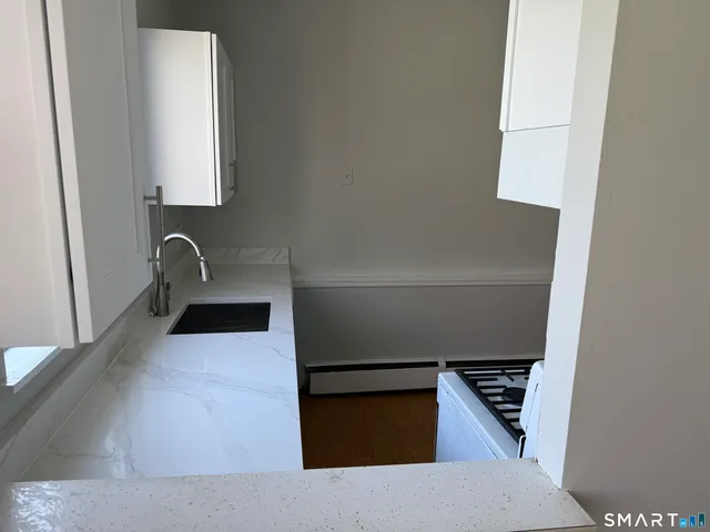 a kitchen with a refrigerator and a sink