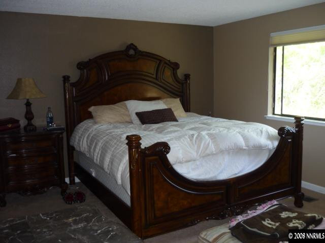 3180 Corey Drive Reno, NV 89509 - Photo 6 of 9 a bed sitting in a bedroom next to a window