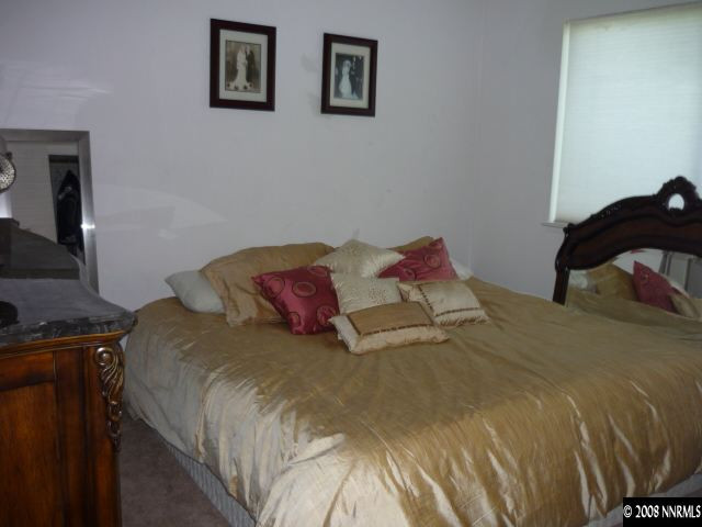 3180 Corey Drive Reno, NV 89509 - Photo 7 of 9 a large bed sitting in a bedroom next to a window