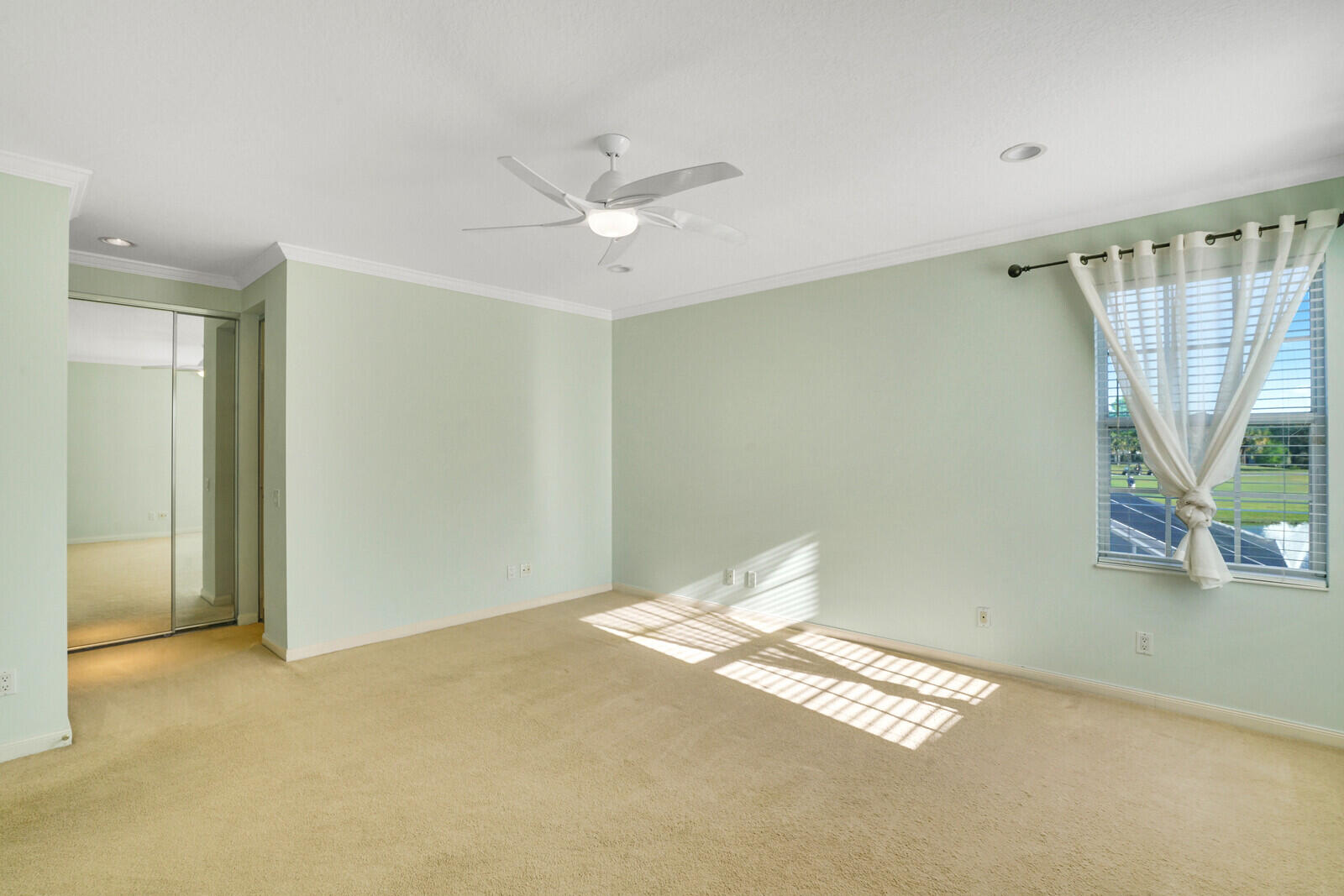 142 Barbados Drive Jupiter, FL 33458 - Photo 19 of 53 a view of empty room with wooden floor and fan