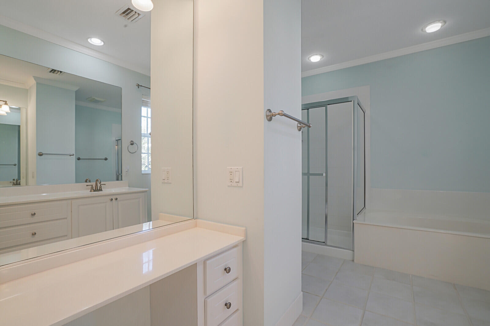 142 Barbados Drive Jupiter, FL 33458 - Photo 22 of 53 a spacious bathroom with a shower a sink and a mirror
