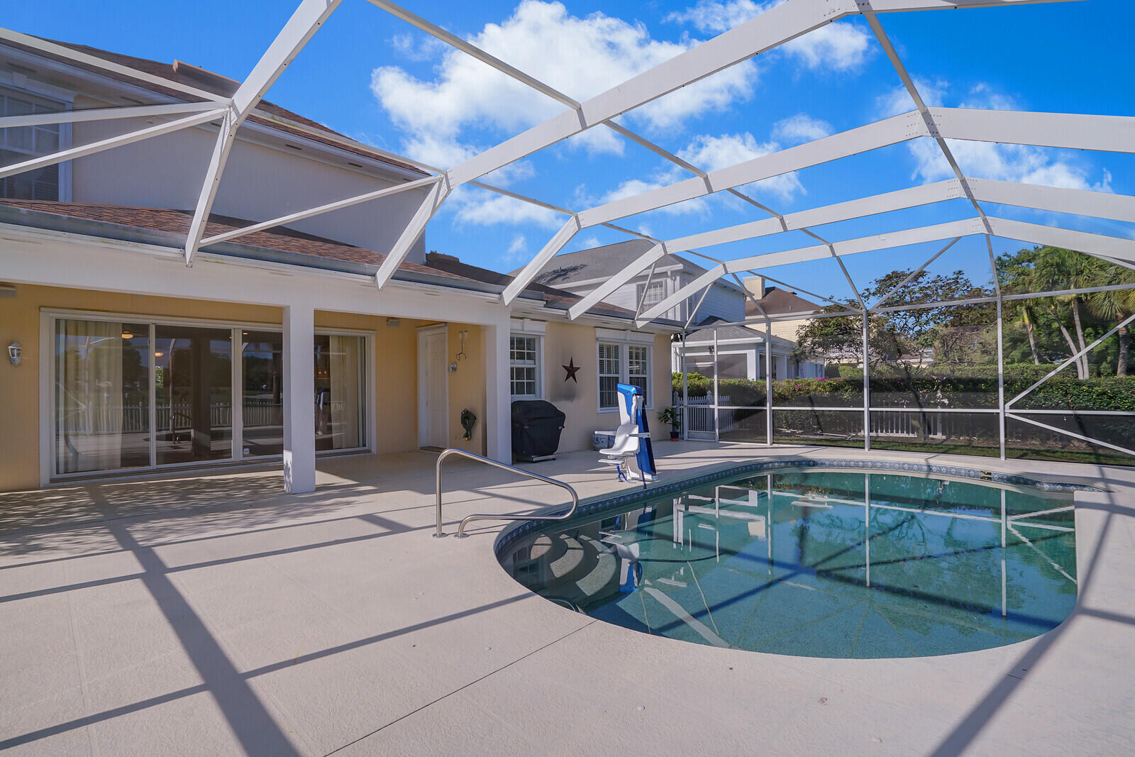 142 Barbados Drive Jupiter, FL 33458 - Photo 35 of 53 a view of a swimming pool with a patio
