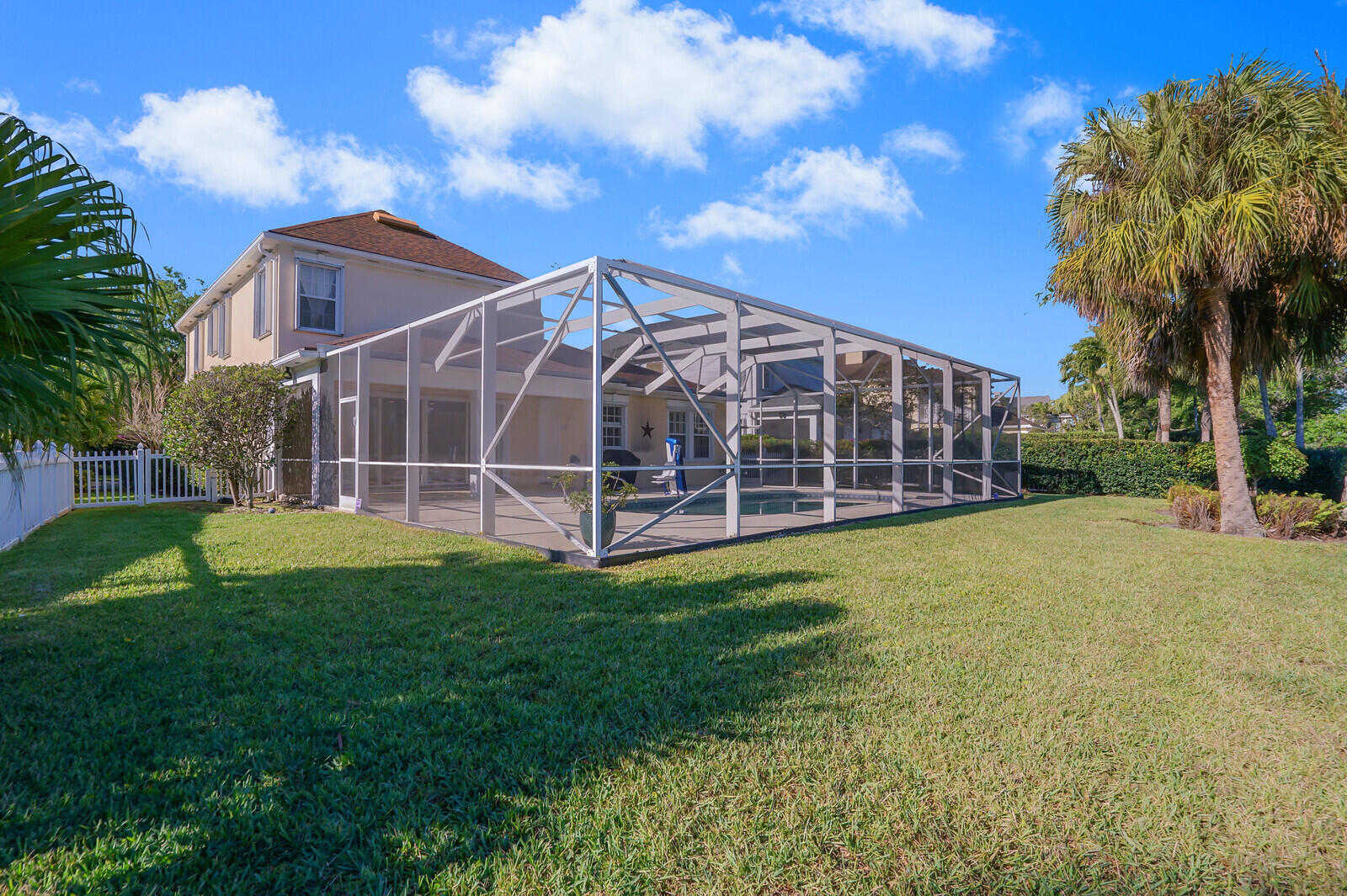 142 Barbados Drive Jupiter, FL 33458 - Photo 39 of 53 a view of a house with a yard and a large tree