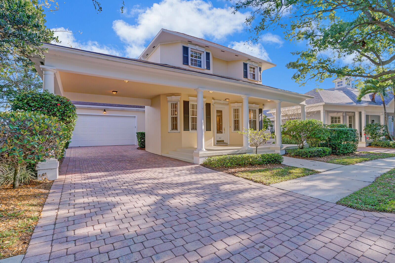 142 Barbados Drive Jupiter, FL 33458 - Photo 49 of 53 a front view of a house with a yard and trees