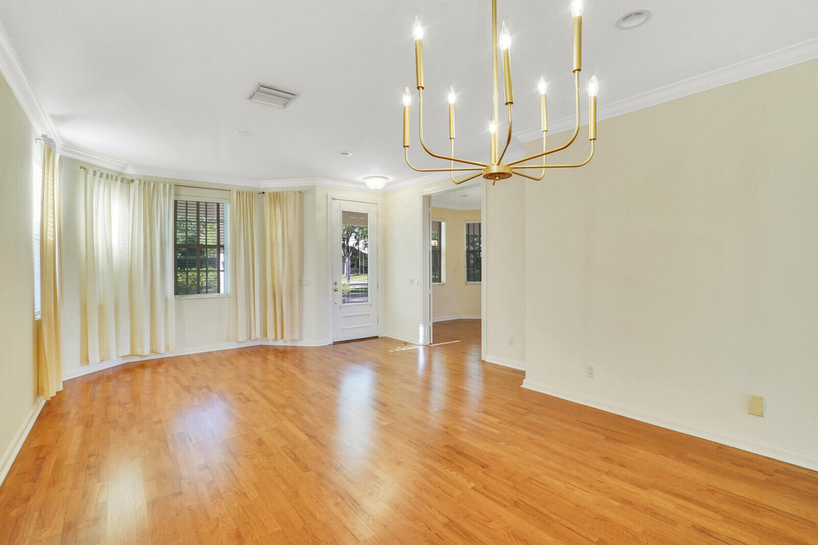 142 Barbados Drive Jupiter, FL 33458 - Photo 5 of 53 a view of an empty room and kitchen with wooden floor