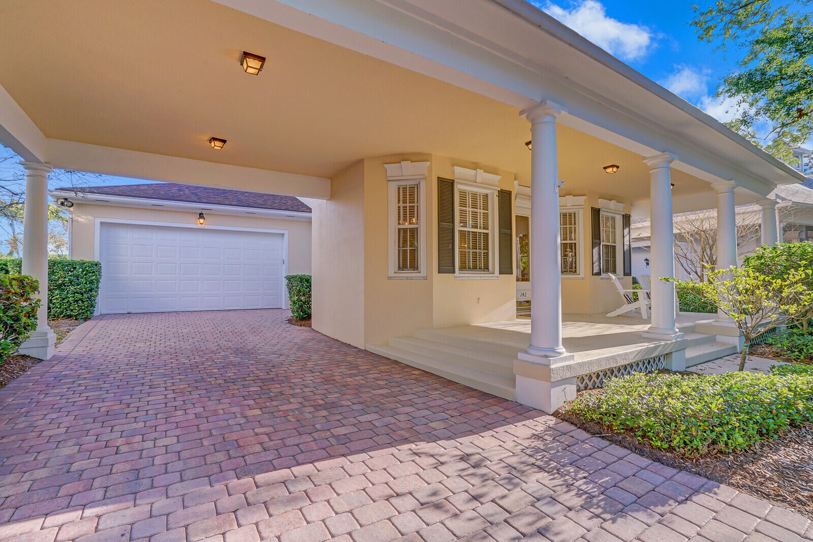142 Barbados Drive Jupiter, FL 33458 - Photo 51 of 53 a front view of a house with garden