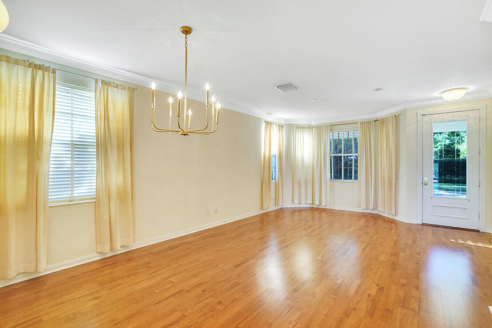 142 Barbados Drive Jupiter, FL 33458 - Photo 6 of 53 a view of empty room with wooden floor and fan