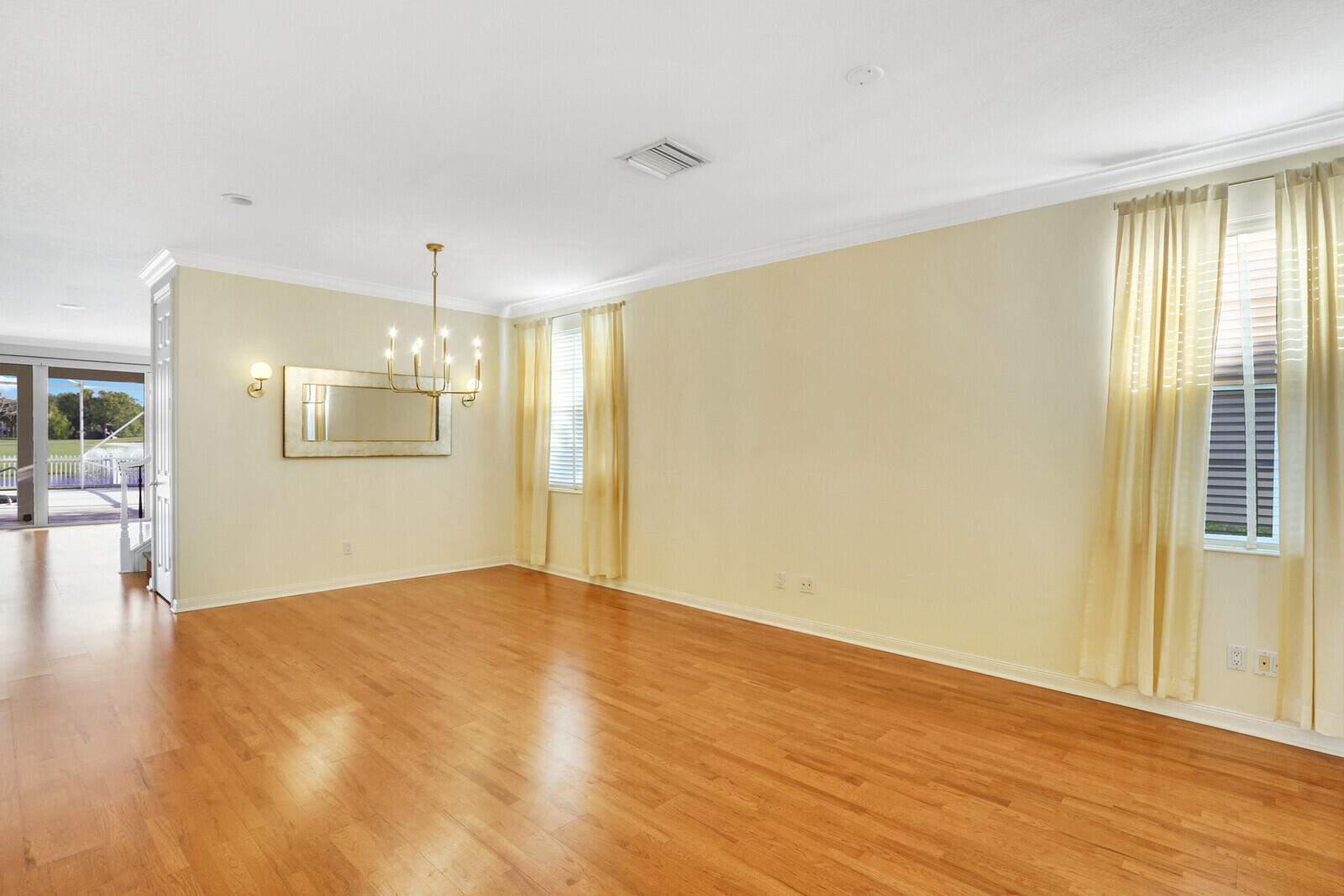 142 Barbados Drive Jupiter, FL 33458 - Photo 7 of 53 a view of an empty room with wooden floor and a window