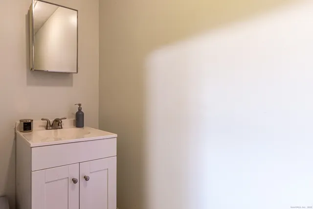 a bedroom with a bed and a wooden floor