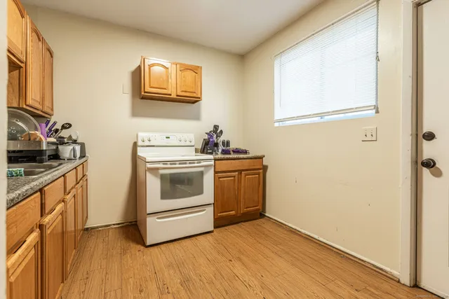 a kitchen with stainless steel appliances granite countertop a sink stove and cabinets