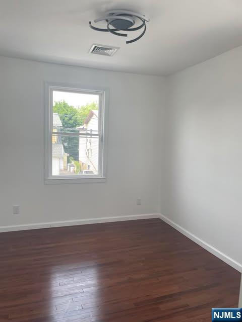18 Pine Street, Unit 2 Lodi, NJ 07644 - Photo 13 of 16 a view of a room with wooden floor and windows