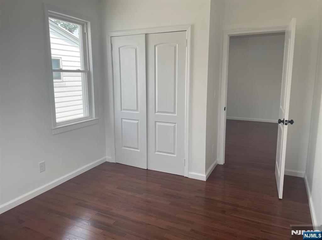 18 Pine Street, Unit 2 Lodi, NJ 07644 - Photo 15 of 16 an empty room with wooden floor and windows
