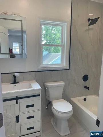 a bathroom with a sink a toilet and a bathtub