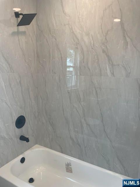 18 Pine Street, Unit 2 Lodi, NJ 07644 - Photo 10 of 16 a bathroom with a bathtub