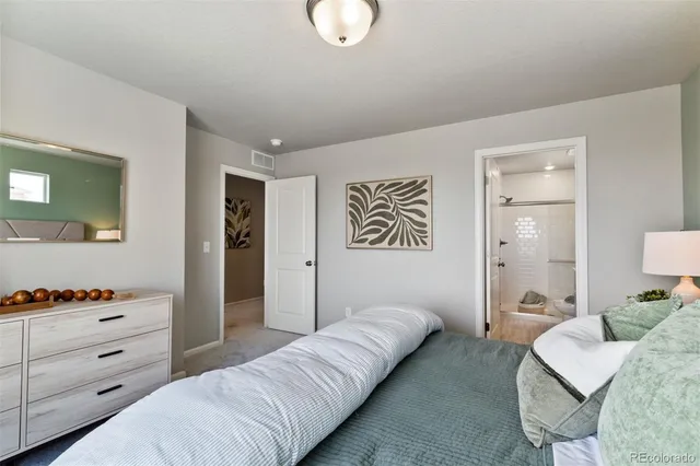 a living room with furniture and a lamp