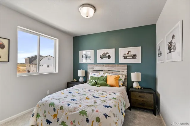 a bedroom with a bed and painting on the wall