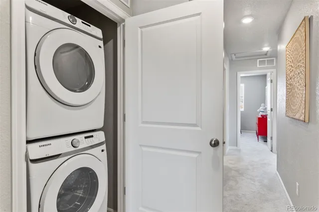 a view of a hallway with washer and dryer