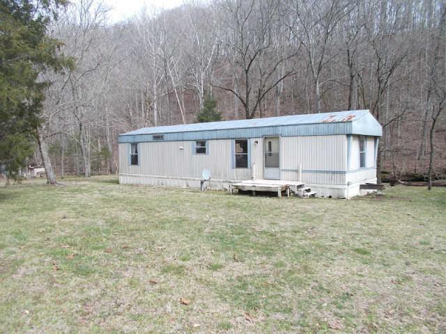 a view of a house with a backyard