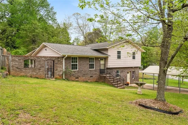 a front view of a house with garden