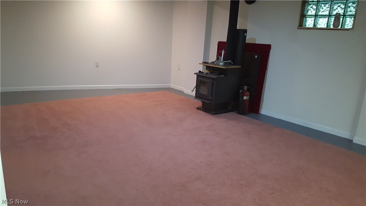 9091 Infirmary Road Ravenna, OH 44266 - Photo 23 of 35 Lower level Rec room with wood burning stove