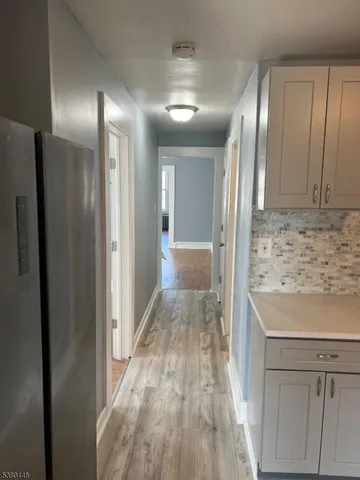 a view of a hallway with wooden floor
