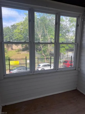 a view of an empty room and a window