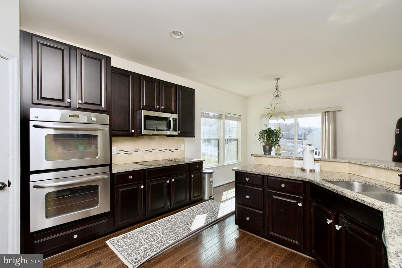 21 Runyon Drive Stafford, VA 22554 - Photo 17 of 43 a kitchen with stainless steel appliances kitchen island granite countertop a stove refrigerator and cabinets