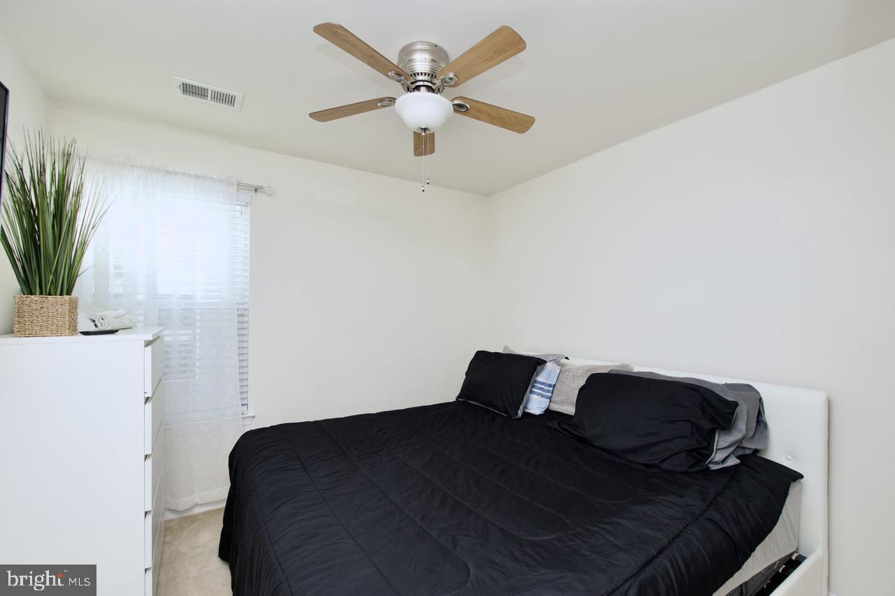 21 Runyon Drive Stafford, VA 22554 - Photo 26 of 43 a bedroom with a bed and a chandelier