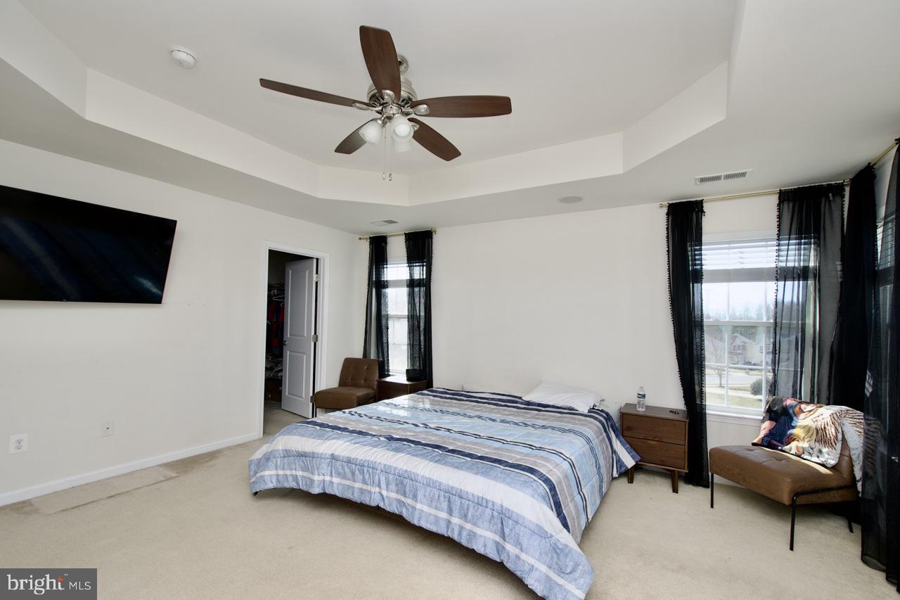 21 Runyon Drive Stafford, VA 22554 - Photo 29 of 43 a bedroom with a bed a flat screen tv and a couch