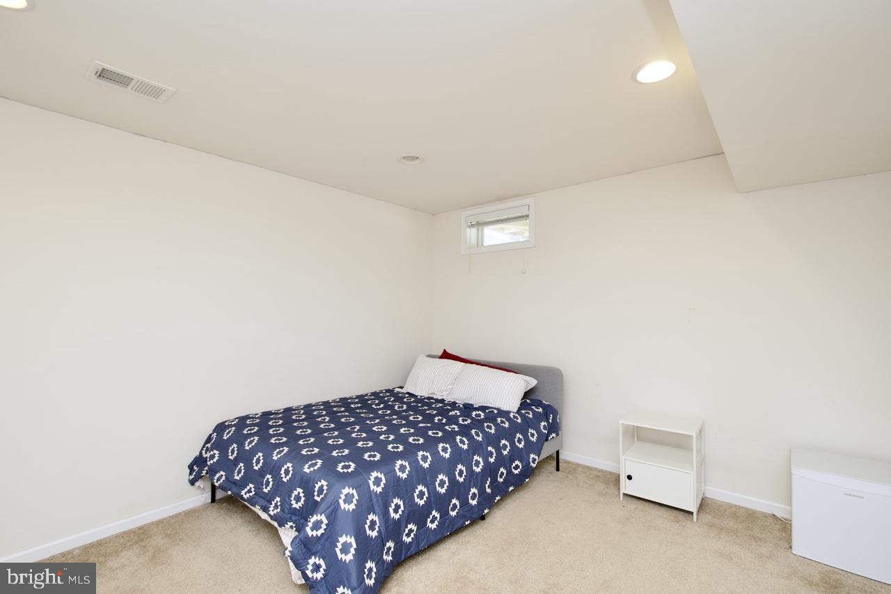 21 Runyon Drive Stafford, VA 22554 - Photo 37 of 43 a bedroom with a bed and a lamp on the dresser