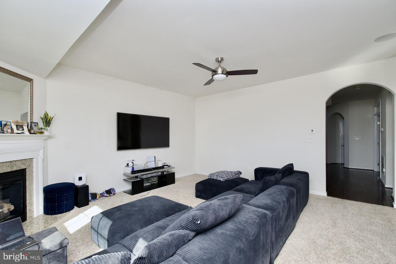 21 Runyon Drive Stafford, VA 22554 - Photo 8 of 43 a living room with furniture a fireplace and a flat screen tv