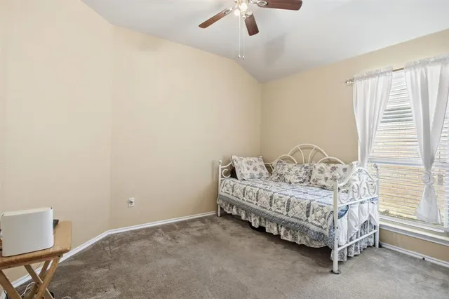 a spacious bedroom with a bed and a window