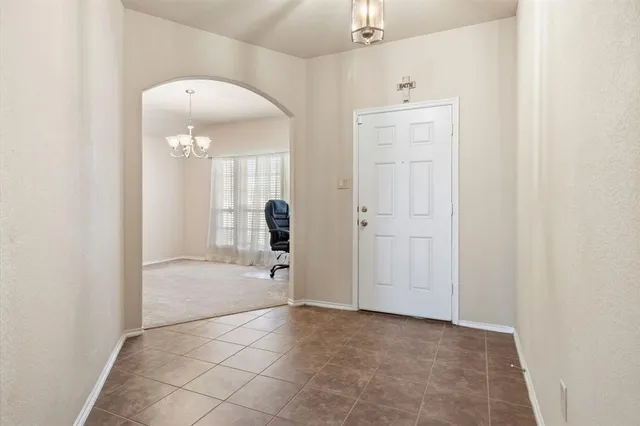 an empty room with a mirror and a shower