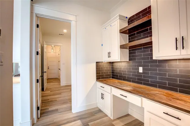 a kitchen with granite countertop a sink and a refrigerator